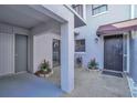 Inviting entrance with tiled courtyard, lush plants, and secure gated entryway at 5122 Cypress Creek Dr # 103, Orlando, FL 32811