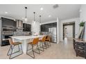 Modern kitchen with stainless steel appliances, dark cabinets, a waterfall island, and pendant lighting at 737 Hyperion Dr, Debary, FL 32713