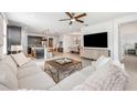 Spacious living room with modern furnishings that opens to the kitchen and dining area at 737 Hyperion Dr, Debary, FL 32713