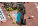 A serene aerial view of a unique, organically-shaped pool nestled in a courtyard at 911 N Orange Ave # 447, Orlando, FL 32801