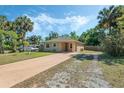 Single-story home with a spacious front yard and a long driveway leading to the entrance at 1101 S Thompson Ave, Deland, FL 32720