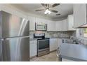 Modern kitchen with stainless steel appliances and white cabinetry at 1101 S Thompson Ave, Deland, FL 32720