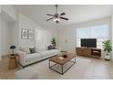 Bright living room featuring neutral decor, comfortable seating, and ample natural light at 1101 S Thompson Ave, Deland, FL 32720