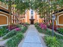 Beautifully landscaped courtyard view with benches and colorful plants at 12544 Floridays Resort Dr # 102, Orlando, FL 32821