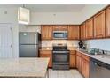 Well-equipped kitchen featuring stainless steel appliances, granite countertops, and ample cabinet space at 12544 Floridays Resort Dr # 102, Orlando, FL 32821