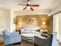 Cozy living room featuring a plush sofa and comfortable armchairs at 12544 Floridays Resort Dr # 102, Orlando, FL 32821