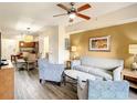 Comfortable living room featuring a view into an eat-in kitchen and dining area at 12544 Floridays Resort Dr # 102, Orlando, FL 32821