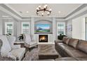 Cozy living room featuring a fireplace, large windows, and comfortable seating at 13628 Abberwick Dr, Orlando, FL 32832