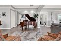 Grand living room featuring a baby grand piano and warm, inviting decor at 13628 Abberwick Dr, Orlando, FL 32832
