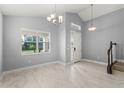 Light-filled living room with high ceilings, tile floors and modern light fixtures at 14399 Wabasso Loop, Winter Garden, FL 34787