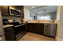 Well-equipped kitchen features stainless steel appliances and a breakfast bar at 14501 Grove Resort Ave # 3601, Winter Garden, FL 34787