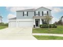 Lovely two-story home featuring a three-car garage, manicured lawn and welcoming front entry at 15216 Langsdale Ct, Mascotte, FL 34753