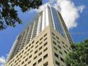 Angled exterior shot of a modern high-rise condo building showing the windows and architectural design at 155 S Court Ave # 1613, Orlando, FL 32801