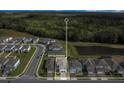 Aerial view of home with a pond and greenery in the neighborhood at 17398 Saw Palmetto Ave, Clermont, FL 34714