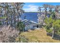 Aerial view showcasing lakefront home and the serene lake at 18951 Lake Pickett Rd, Orlando, FL 32820