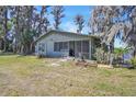 Quaint lake house surrounded by lush trees and greenery at 18951 Lake Pickett Rd, Orlando, FL 32820