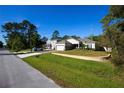 A single Gathering house with well-maintained lawn, beautiful landscaping and brick retention wall at 2050 1St Ave, Deland, FL 32724
