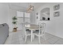 Dining area featuring an oval wooden table, seating for six, and stylish light fixture at 2136 Crofton Ave, Davenport, FL 33837