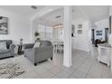 Inviting living room and dining room featuring archways, tile flooring, and neutral decor at 2136 Crofton Ave, Davenport, FL 33837