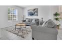 Cozy living room with large windows, comfortable seating, and a decorative rug at 2136 Crofton Ave, Davenport, FL 33837