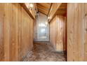 Interior hallway featuring wood paneled walls, high vaulted ceiling, and unique vintage carpeting at 220 Wekiva Park Drive, Sanford, FL 32771