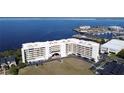 An aerial view of the white condo building and expansive marina on the water at 225 W Seminole Blvd # 213, Sanford, FL 32771