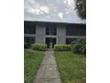 Two-story condo building featuring well-maintained landscaping and neutral color palette at 2548 Oak Park Way # 102, Orlando, FL 32822
