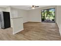 Spacious living area with wood-look flooring and access to a screened lanai with peaceful views at 2548 Oak Park Way # 102, Orlando, FL 32822