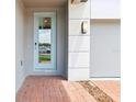 Close-up of the front entrance, featuring brickwork and a light blue door at 2917 Wild Olive Dr, St Cloud, FL 34772