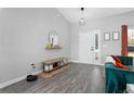 Bright entryway featuring stylish wood flooring, a decorative mirror, and a cozy bench at 1139 9Th Ave, Deland, FL 32724