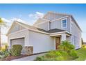 Lovely two-story home with gray siding, a manicured lawn, and a welcoming front entrance at 1224 Teal Creek Dr, St Cloud, FL 34771