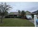 Inviting one-story home with a well-maintained lawn and mature landscaping at 123 Breezy Oaks Ct, Davenport, FL 33896