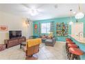 Open-concept living room showcases a large sofa, modern lighting, and views into the kitchen at 12862 Strode Ln, Windermere, FL 34786
