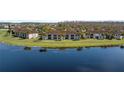 Aerial view of condos with lake and lush green space, nestled in a quiet neighborhood at 13852 Timberbrooke Dr # 203, Orlando, FL 32824