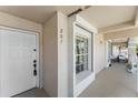 Inviting condo entrance featuring a secure door, window, and covered porch area at 13852 Timberbrooke Dr # 203, Orlando, FL 32824