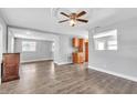 Open living room featuring hardwood floors, a ceiling fan with an eat-in kitchen at 1607 India Palm Dr, Edgewater, FL 32132