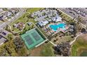 Aerial view showcasing community amenities, including a pool, tennis courts, and playground at 1696 Tohoqua Blvd, Kissimmee, FL 34744