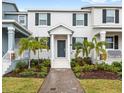 Two-story townhome with a neutral exterior, manicured landscaping, and a welcoming front entry at 1696 Tohoqua Blvd, Kissimmee, FL 34744