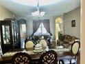 Dining room with elegant furniture and decorative accents, adjacent to a living area at 1838 Palmerston Cir, Ocoee, FL 34761