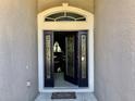 Open front door featuring glass panels and transom window allowing light into the home at 1838 Palmerston Cir, Ocoee, FL 34761