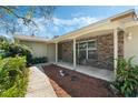 Inviting front porch with brick accents and a covered entrance, complemented by attractive landscaping at 1873 Poinciana Rd, Winter Park, FL 32792
