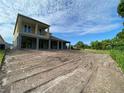 Expansive backyard with view from the rear of the home under partly cloudy sky at 2430 Francisco Art Ct, Oviedo, FL 32765