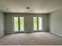 Well-lit bedroom with double doors leading to a private balcony at 2430 Francisco Art Ct, Oviedo, FL 32765