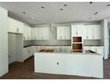 Spacious kitchen featuring white cabinets, a center island, and stainless steel vent hood at 2430 Francisco Art Ct, Oviedo, FL 32765