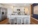 Modern kitchen with stainless steel appliances, white cabinets, and a spacious island at 2911 Moulin Rd, Davenport, FL 33837