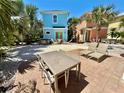 Backyard oasis with patio, dining, lounge seating, and lush landscaping at 3095 Key Lime Loop, Kissimmee, FL 34747