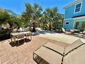 Inviting patio space with outdoor dining and lounge seating, perfect for relaxing in a tropical paradise at 3095 Key Lime Loop, Kissimmee, FL 34747