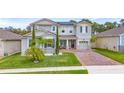Charming two-story home with a well-manicured lawn and inviting brick-paved driveway at 3252 Jackson Bluff Way, Clermont, FL 34711