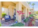 Charming front porch with comfortable wicker furniture and lush landscaping at 3621 Casello Dr, New Smyrna Beach, FL 32168