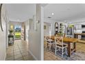 Open-concept home featuring a tiled entryway, dining area, and a glimpse of a modern kitchen layout at 425 N Pine Meadow Dr, Debary, FL 32713